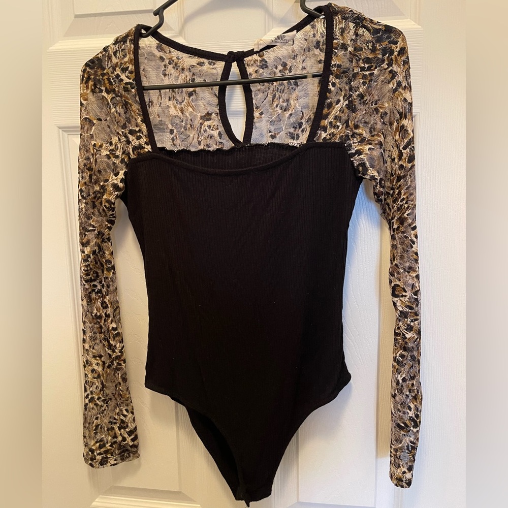 Cheetah print see through sleeves. Bodysuit. Tried on but never worn otherwise.